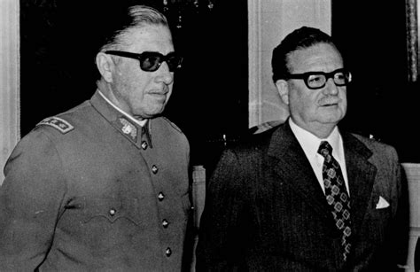 Stamp of salvador allende on the background of the burning palace moncada, printed c. Cuarenta y dos años después del derrocamiento de Salvador ...