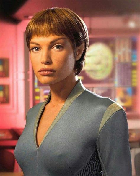 A Star Trek Enterprise Character Standing In Front Of A Computer Screen