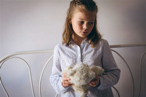 Sad Girl Holding A Teddy Bear At Home — Standing Household Stock