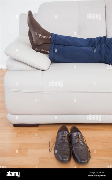 Tired Businessman Lying On Sofa With Shoes Off Stock Photo Alamy