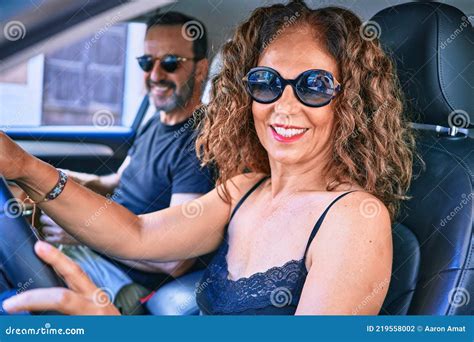 Middle Age Beautiful Couple On Vacation Wearing Sunglasses Smiling
