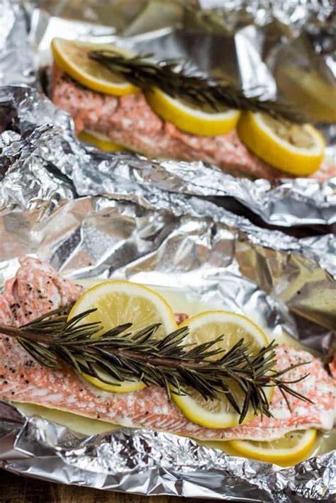 Place salmon onto foil, season with salt and pepper and squeeze 1/4 of lemon over. Baked Salmon In Foil Packets - Dash of Herbs