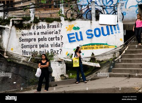 local brazilian women waiting for public transport motorbike taxi in a favela in rio de