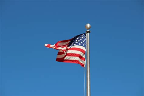 Free Stock Photo Of American Flag Waving On Pole In Blue Sky