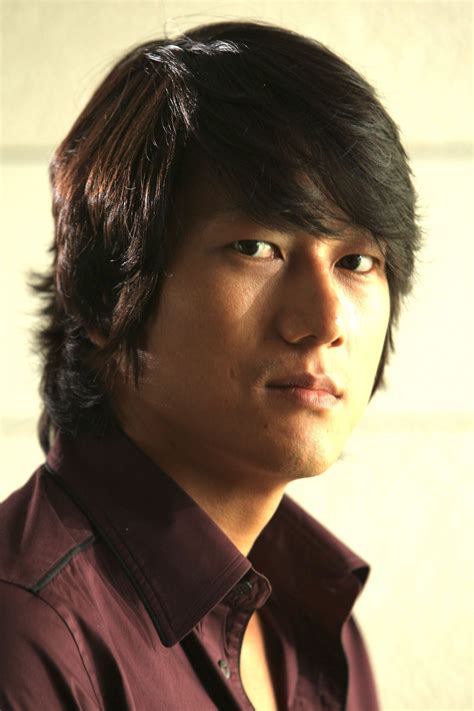 The hair is long and styled in a messy fashion. 10 Great Hair Looks for Asian Men