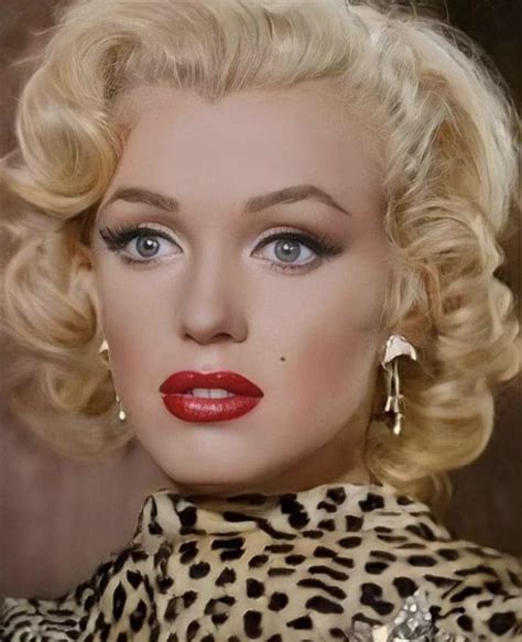 A Close Up Of A Woman With Blonde Hair And Blue Eyes Wearing Leopard Print Dress