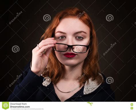 Beautiful Nerd Girl Or Young Woman Looking Over Eyeglasses