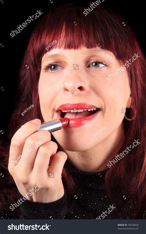 Close Up Of Woman Applying Red Lipstick To Her Luscious Lips Stock