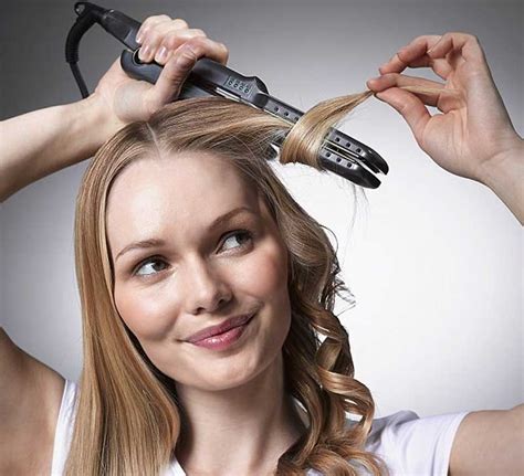 Feed a section of hair through your open flat iron, clamp the plates down about an inch or two from your roots, and then wrap the section around the iron once, sliding it down the length of the section. Why Use a Curling Wand to Curl Hair and Not a Straightener