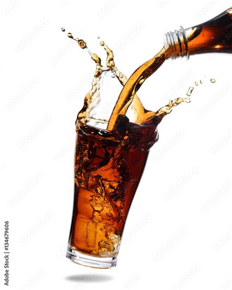 Pouring Cola From Bottle Into Glass With Splashing Isolated White