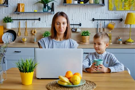 Working Mother Concept Young Woman Working On Laptop With Her Child