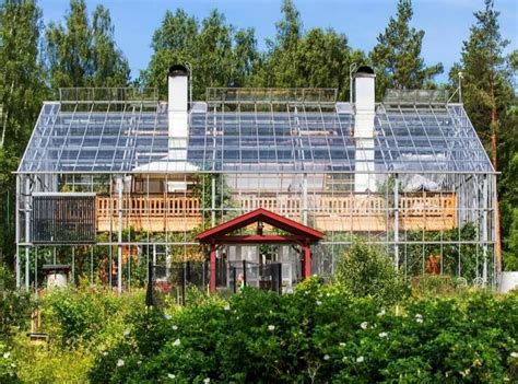 A Traditional Swedish Log Cabin Encased In A Green House Allows A