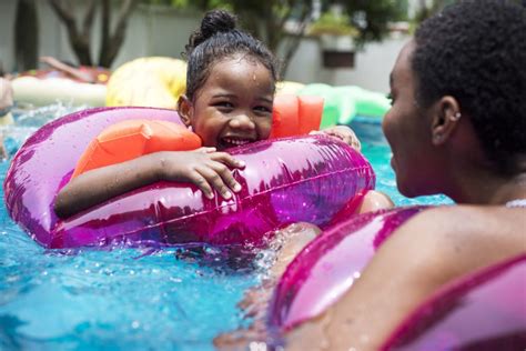 Closeup Of Black Mother And Daughter Enjoying The Pool With Infl