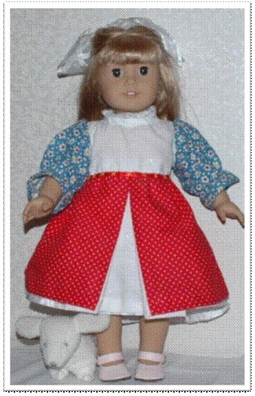 The Doll Is Wearing A Red And White Dress