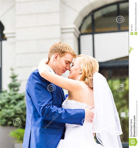 Beautiful Bride And Groom Embracing On Their Wedding Day Outdoors Stock