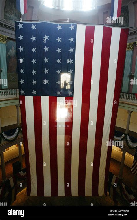 A Tourist Checks Out The Oversized Garrison Flag After It Is Hoisted To