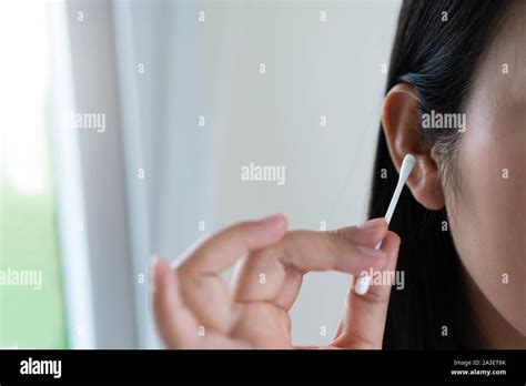 Woman Cleaning The Ear With A Cotton Swab Healthcare And Ear Cleaning