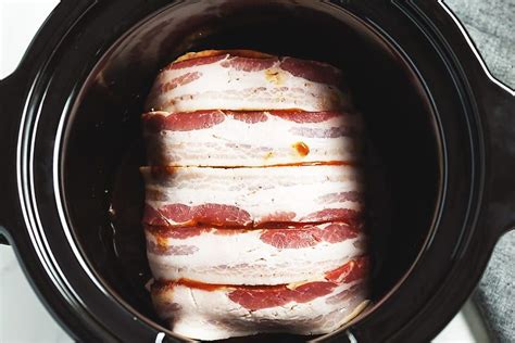 Perfectly Cooked Crock Pot Pork Roast Wrapped In Bacon And Basted With