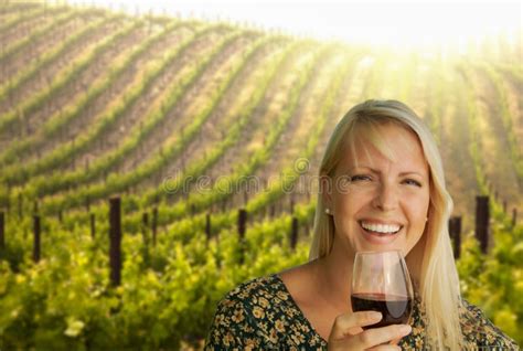 Beautiful Blonde Woman Enjoys Glass Of Wine In A Vineyard Stock Image