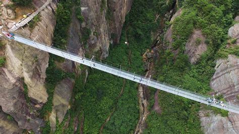 Stretched 300 metres between two canyons, the bridge, which was frightening enough to cross when it was made of wood. This vertigo-inducing glass bridge in China just opened to ...