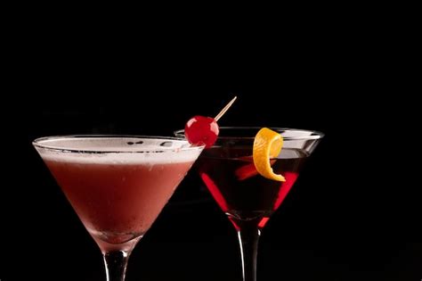 Premium Photo Two Martini Glasses With Close Up On Cherry Cocktails And Red Liquid And Orange