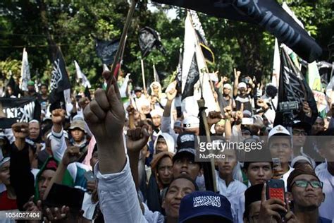 Indonesian Muslims Carrying Tawheed Flags And Other Attributes Staged