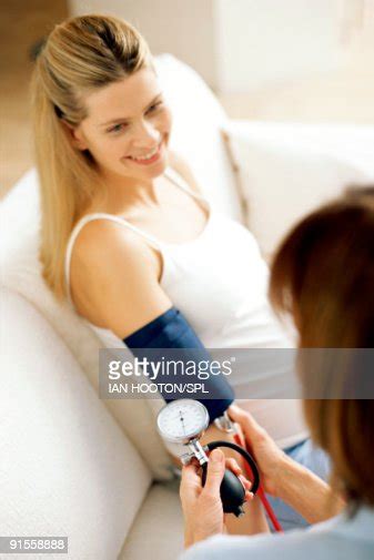 Doctor Checking Womans Blood Pressure High Res Stock Photo Getty Images