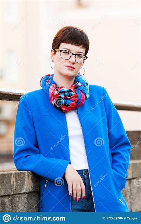 A Short Haired Brunette In Casual Urban Clothes In Blue Tones Stock