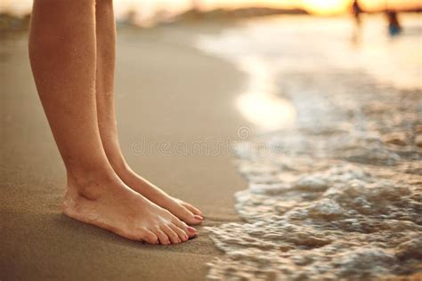 Female Legs On The Beach Sand Of The Sea Stock Photo Image Of Woman
