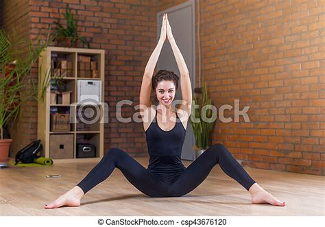 Portrait Of Beautiful Smiling Woman Doing Stretching Exercise Sitting