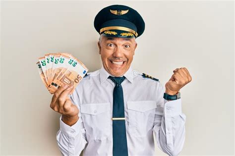 Handsome Middle Age Mature Man Wearing Airplane Pilot Uniform Holding