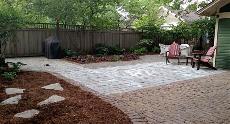 Tumbled Bluestone Permeable Patio With Reclaimed Brick Border And