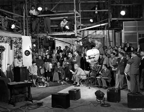 Black And White Photograph Of People In An Industrial Setting With