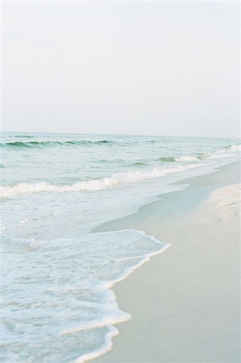 A Light Gray Blue Sky White Sand Beach Pale Aqua Water Edged In