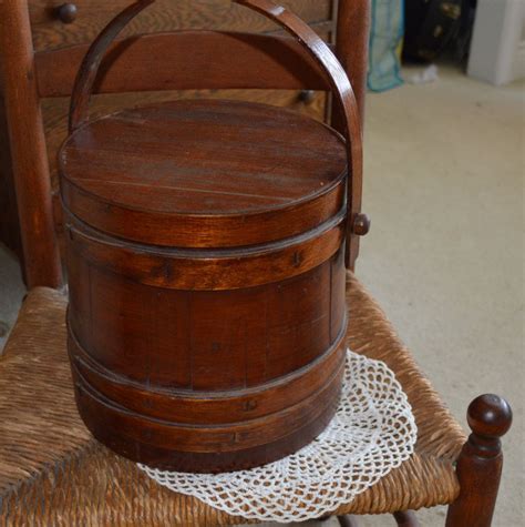 A Wooden Bucket Sitting On Top Of A Chair
