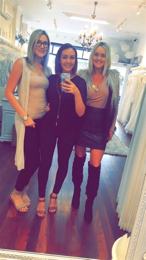Three Women Standing In Front Of A Mirror Taking A Selfie