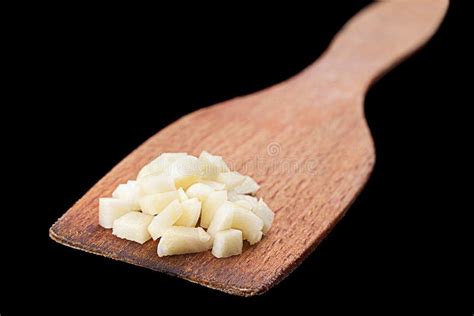 Chopped Garlic In A Plate With Garlic Bulb And Cloves Stock Image