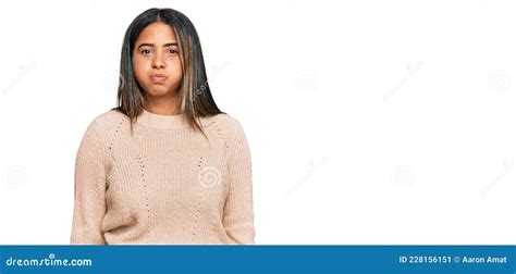 Young Latin Girl Wearing Wool Winter Sweater Puffing Cheeks With Funny