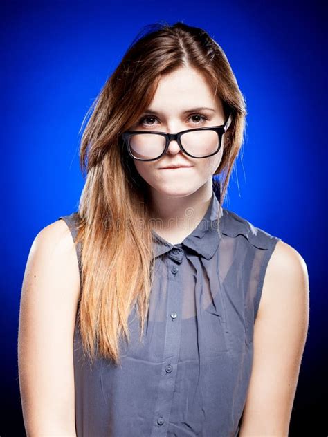 Portrait Of Strict Young Woman With Nerd Glasses And Chewing Gum Stock