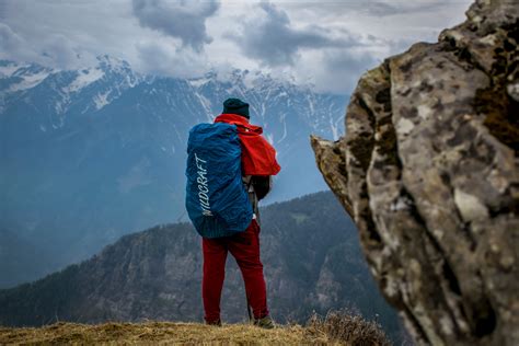 Man Wearing Blue Hoodie Standing On Top Of Mountain · Free