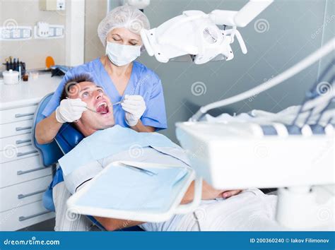 Female Dentist Treating Male Patient Stock Photo Image Of Dentistry