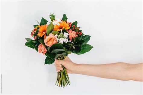 Womans Hand Holding A Bouquet Of Flowers By Stocksy Contributor