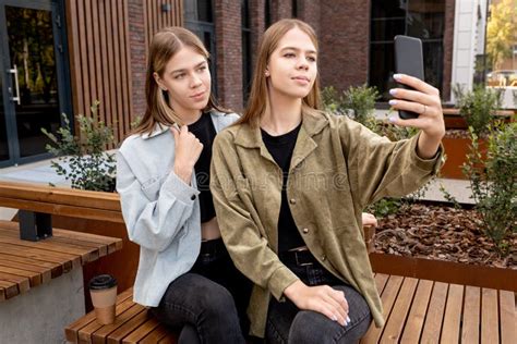 Pretty Teenage Twins Making Selfie While Sitting On Bench Stock Image Image Of Cute Caucasian