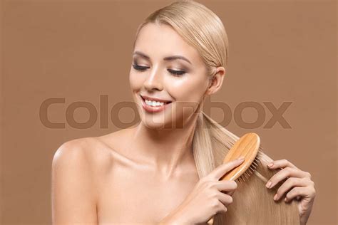 Blonde Woman Combing Long Hair Stock Image Colourbox