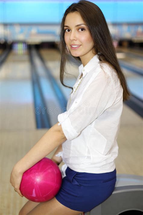 Young Woman Holds Ball And Sits In Bowling Club Stock Photo Image Of