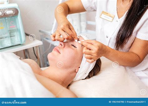Beauty Saloncosmetologist Gives A Facial Massage To The Client Concept Of Professional