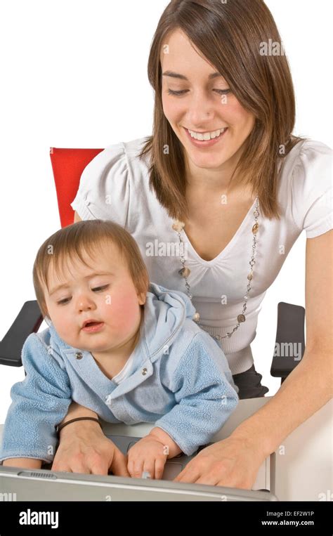 Mother Sitting With Toddler On Her Lap While Typing Stock Photo Alamy
