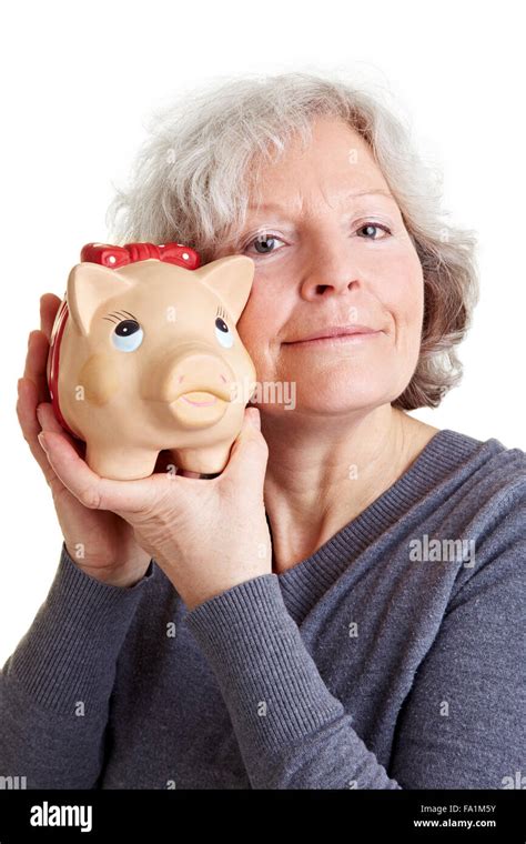 Happy Old Woman Holding A Piggy Bank To Her Cheek Stock Photo Alamy