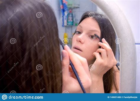 Woman Applying Mascara On Her Eyelashes Face Close Up Woman Makes