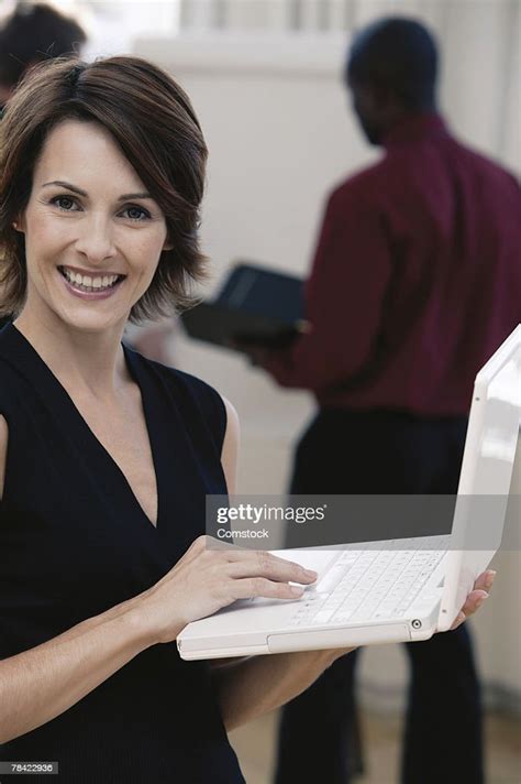Businesswoman Using Laptop While Standing Up High Res Stock Photo